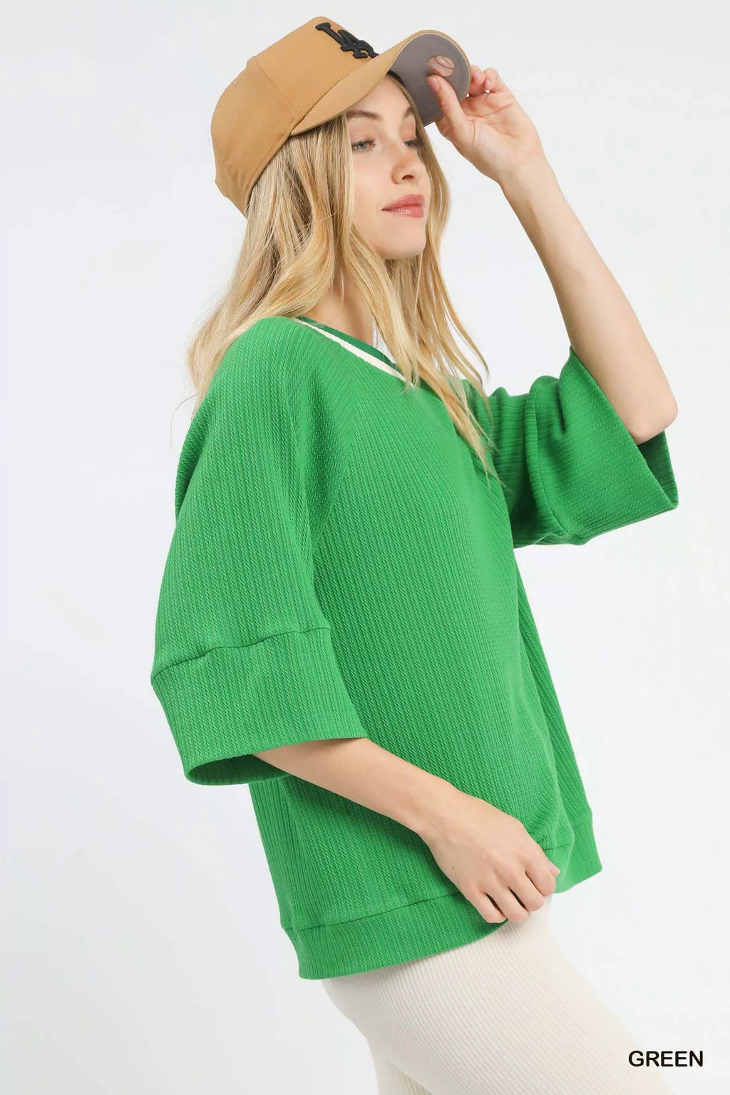 Umgee ribbed knit top with contrast trim, featuring a fitted design and stylish neckline, styled on a model.