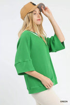 Umgee ribbed knit top with contrast trim, featuring a fitted design and stylish neckline, styled on a model.