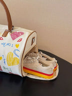 Printed duffel bag with adjustable strap from Shopimist, showing the spacious bag with colorful printed design and sturdy handles.