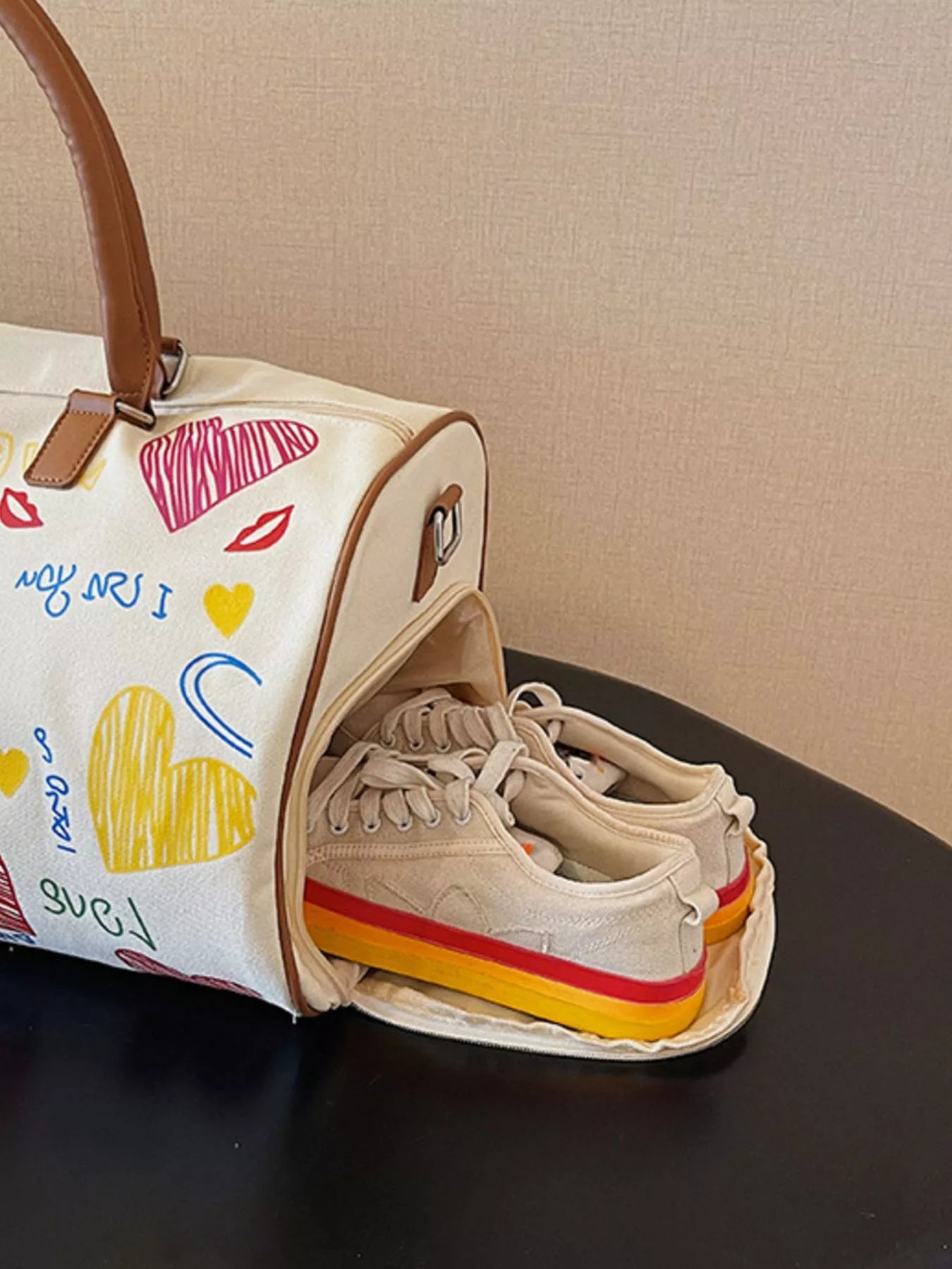Printed duffel bag with adjustable strap from Shopimist, showing the spacious bag with colorful printed design and sturdy handles.