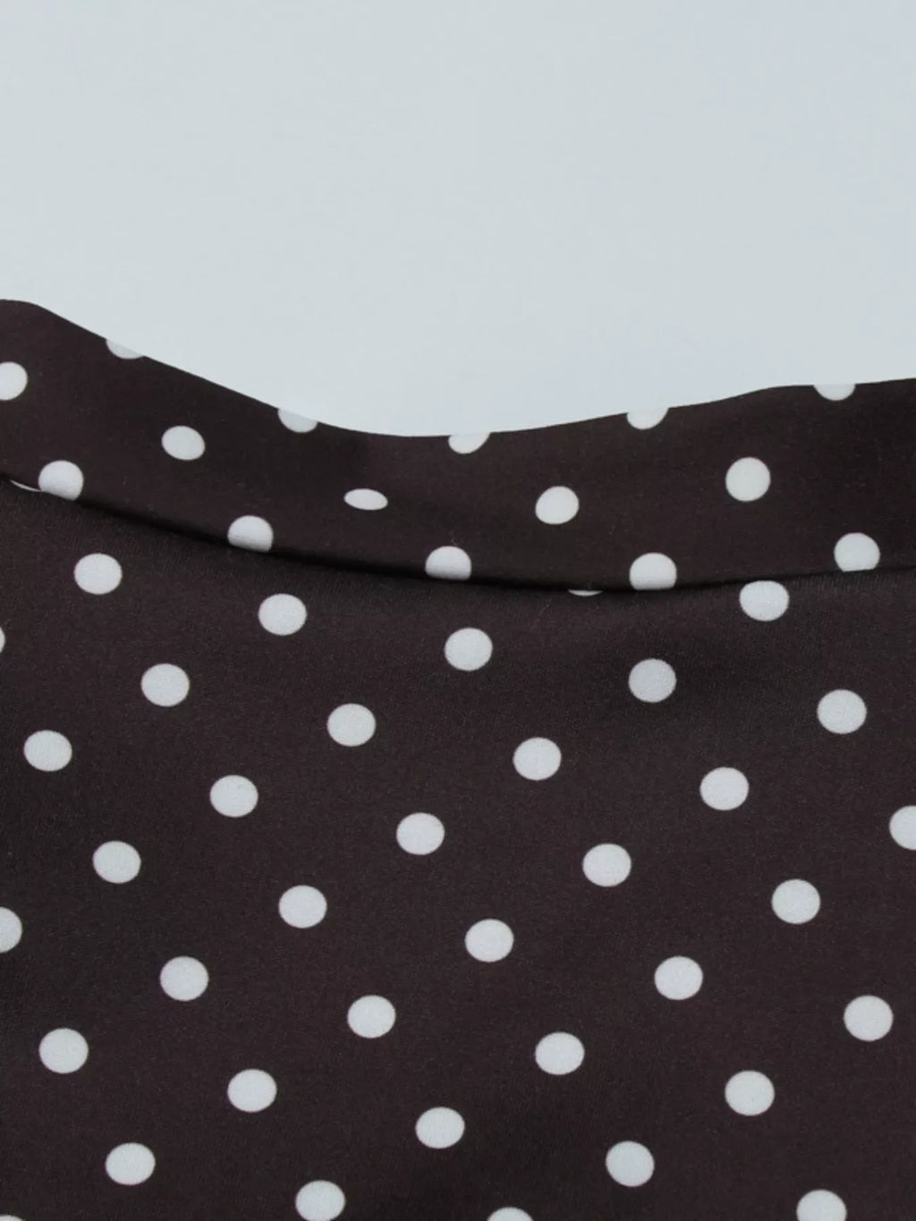 Polka dot cut-out front mini dress by Shopimist featuring a stylish design with a fitted silhouette and playful polka dot pattern.