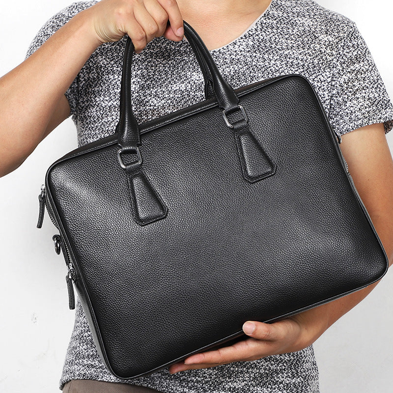Men's leather briefcase by Plush Fashion Hub with cowhide material, large capacity, horizontal design, and professional style.