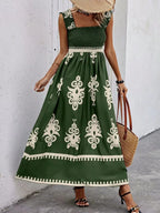 Smocked printed wide strap maxi dress by Plush Fashion Hub featuring a flowy silhouette and vibrant floral pattern.