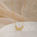 Sterling silver beaded necklace from Shopimist featuring evenly spaced round silver beads on a delicate chain.