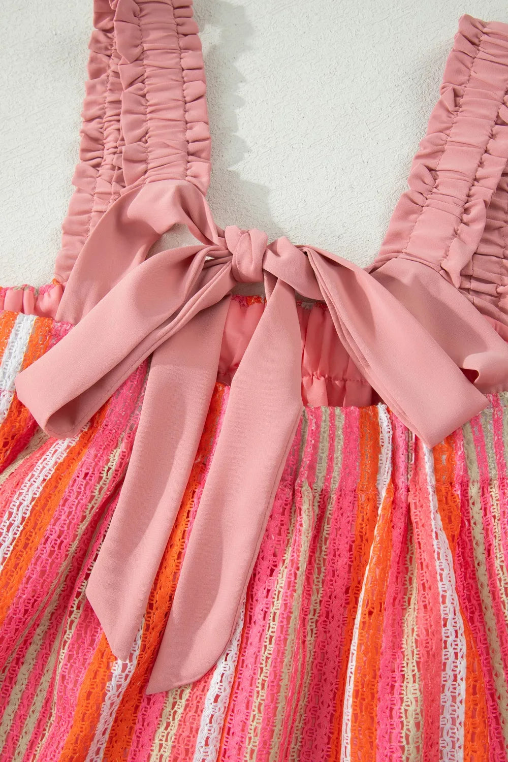 Plush Fashion Hub Stripe Ruffled Straps Ribbon Knot Maxi Dress with flowy fabric and vacation-ready design, featuring striped pattern and ruffles.