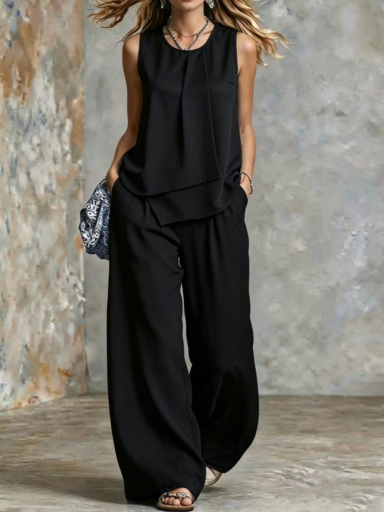 Women's sleeveless two-piece set with solid color wide-leg pants and matching top, stylish ensemble by Plush Fashion Hub.