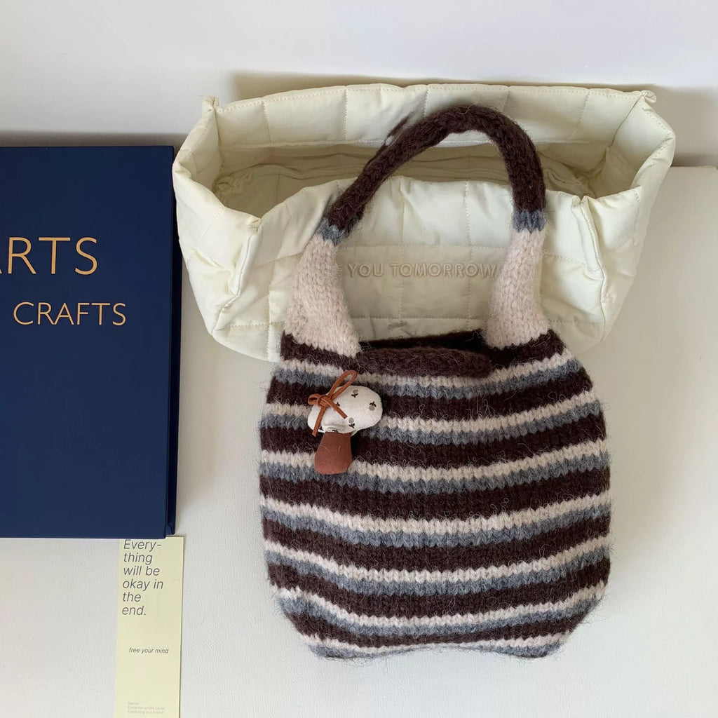 Knitted striped handbag from Shopimist featuring a colorful, woven design, with a spacious interior and sturdy handles.