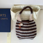 Knitted striped handbag from Shopimist featuring a colorful, woven design, with a spacious interior and sturdy handles.