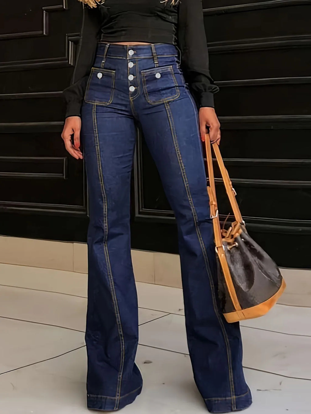 Plush Fashion Shop denim flare jeans with front and back pockets, featuring a high-waisted fit and wide leg opening.