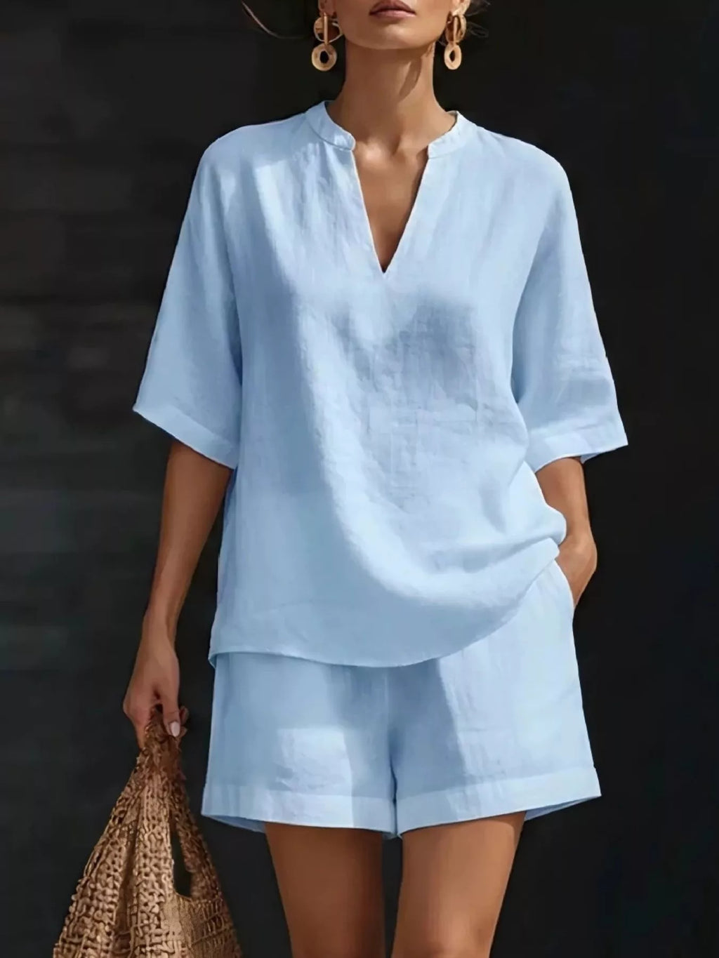 Plus size Trendsi full size notched half sleeve top and shorts set, featuring a stylish coordinated outfit with a comfortable fit.