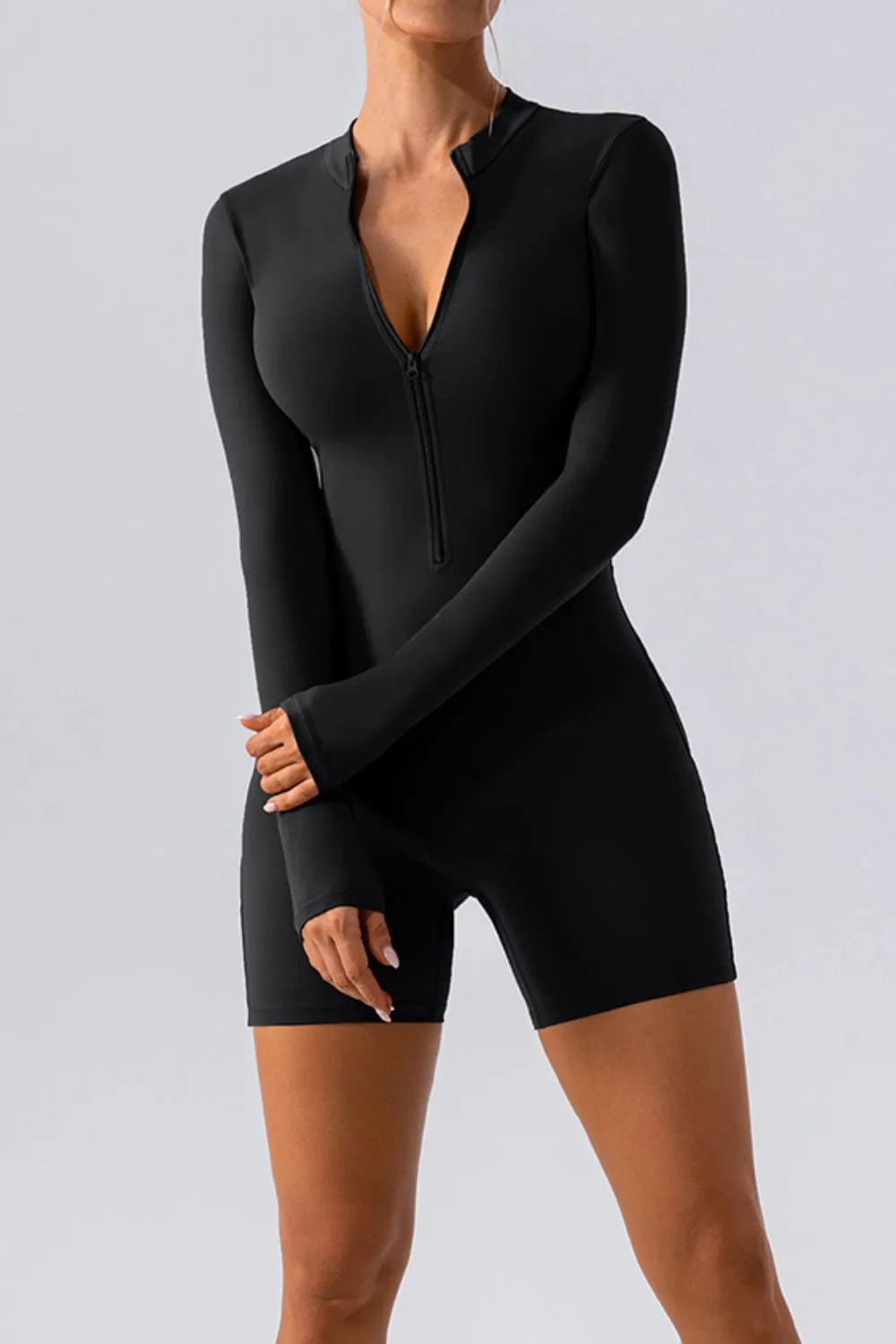 Trendsi half zip long sleeve active romper showing a sleek, fitted design ideal for active wear and workouts.