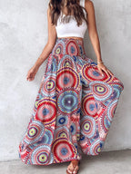 Printed wide-leg pants by Shopimist featuring a flowy design and bold pattern, shown on a model standing against a neutral background.