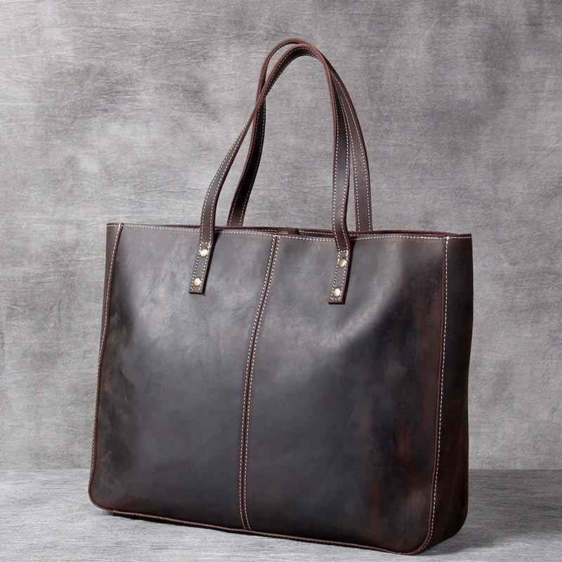 Simple retro first layer cowhide large-capacity men's handbag with a minimalist design from Plush Fashion Hub.