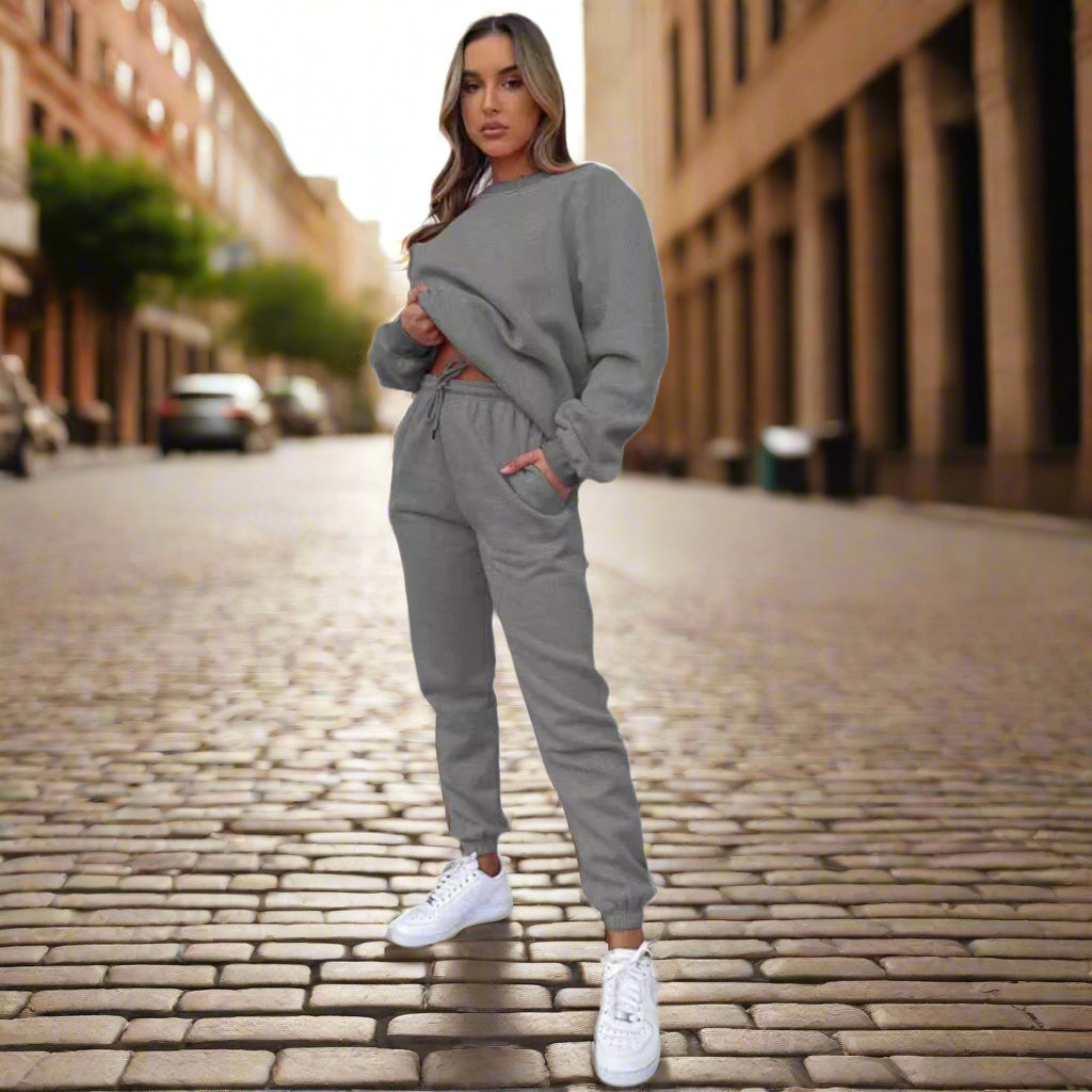 Women's solid color round neck pullover sweatshirt and pants set by Plush Fashion Hub, casualwear with comfortable fit.