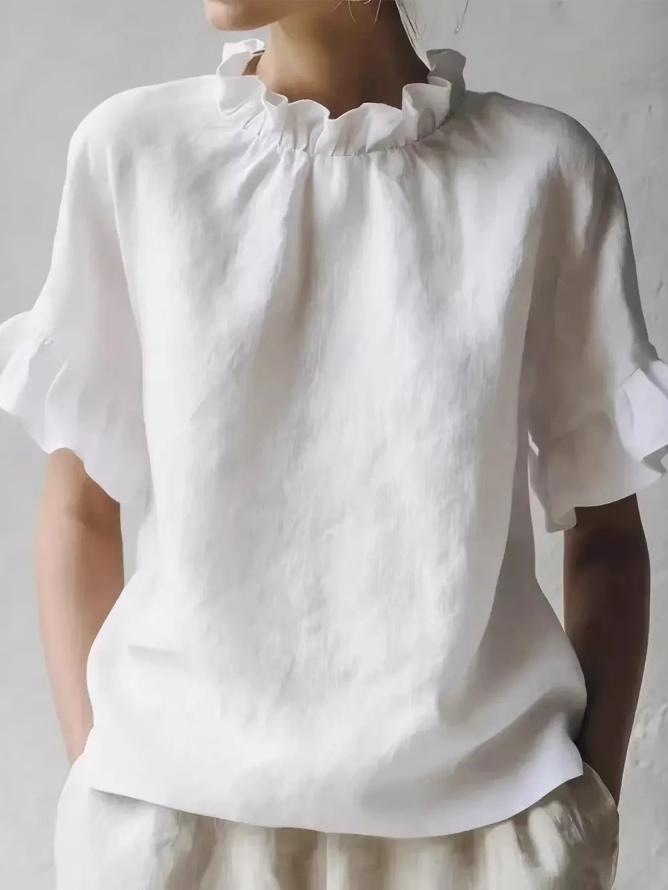 Plus size ruffled neck blouse with half sleeves from Plush Fashion Hub, featuring a stylish full-size fit and feminine ruffle detail.