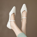 Women's floral detail FitiqueFit pointed toe low square heel buckle flats, stylish dress shoes with floral accents on beige background.
