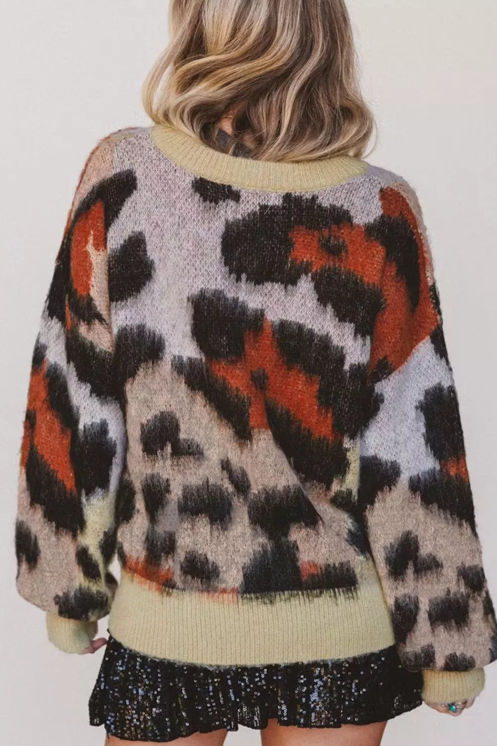 Leopard print drop shoulder long sleeve sweater with round neck, stylish and cozy from Trendsi.