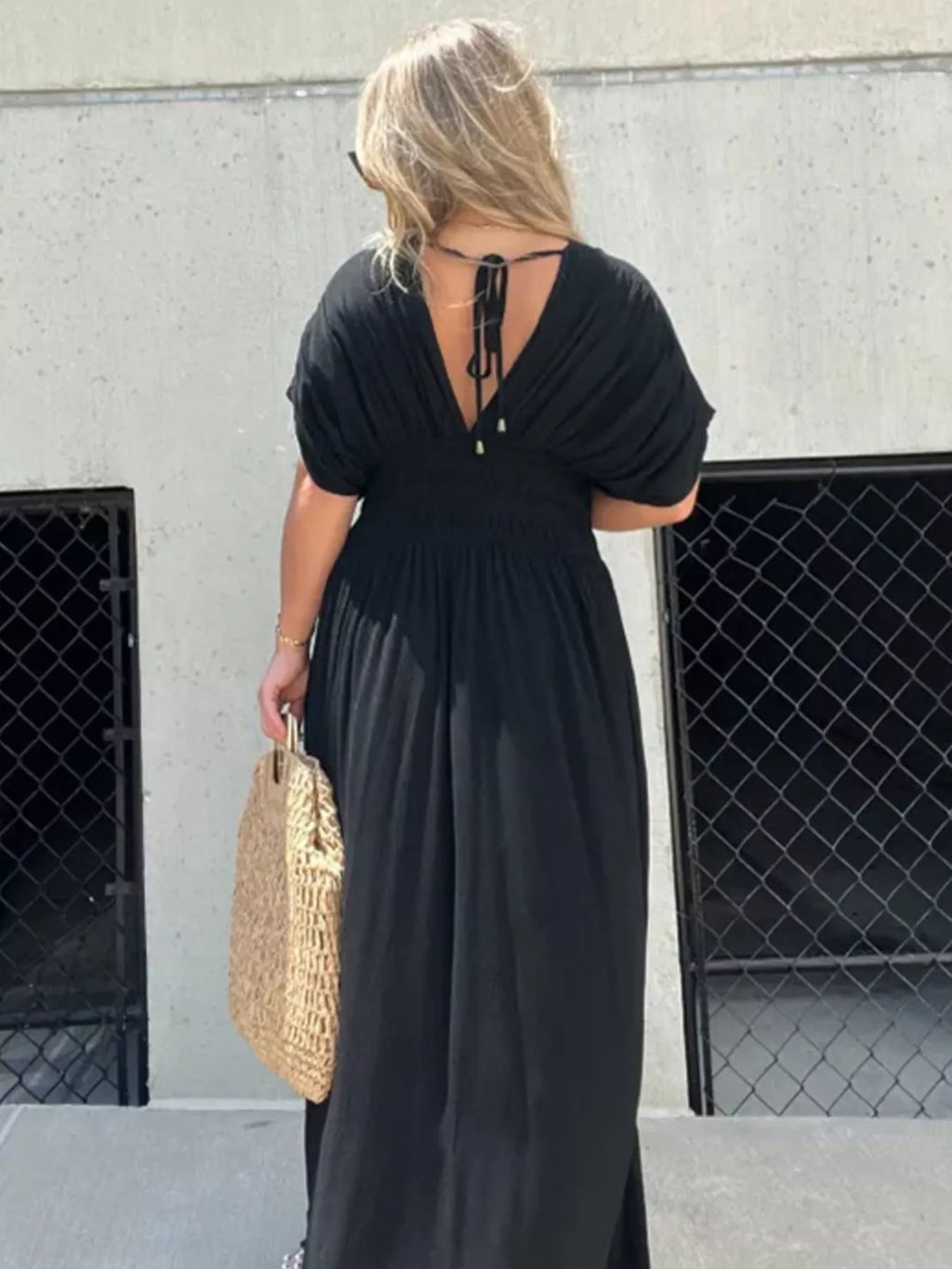 Full size slit V-neck smocked waist maxi dress by Trendsi, featuring a flowing silhouette and elegant design in the image.