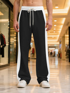 Plus size men's sweatpants with contrast stripe design and drawstring waist from Trendsi, shown in a full-length view.