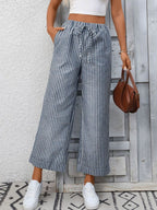Women’s striped wide-leg drawstring pants with pockets by Trendsi, featuring a relaxed fit and stylish design.