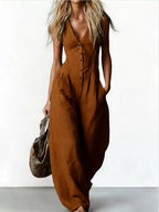 V-neck button-down wide-leg jumpsuit by Trendsi, featuring a stylish fit and flowing wide-leg design, shown on a model.