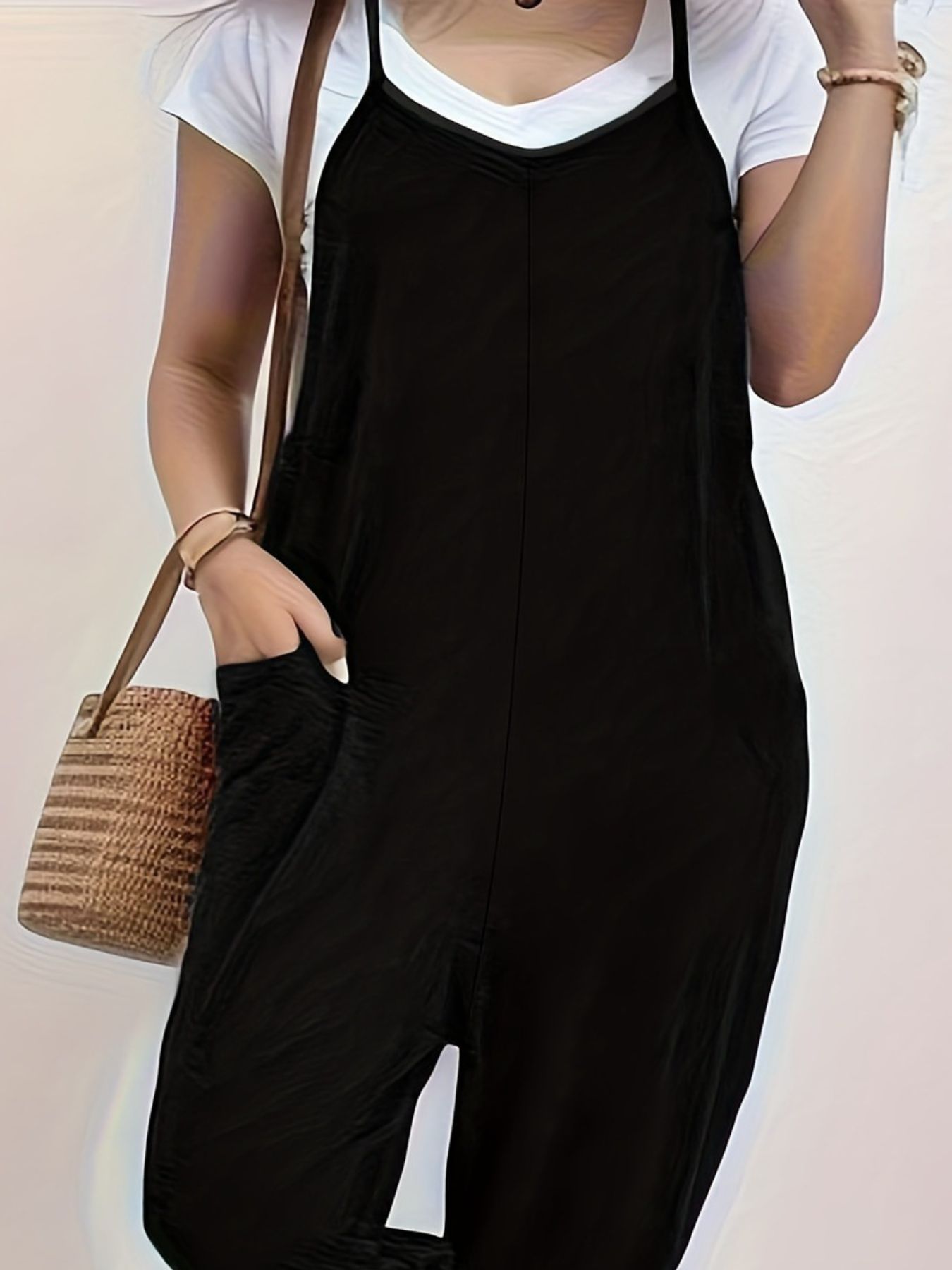 Casual loose fit spaghetti strap jumpsuit with pockets by Trendsi, featuring a relaxed style and lightweight fabric.