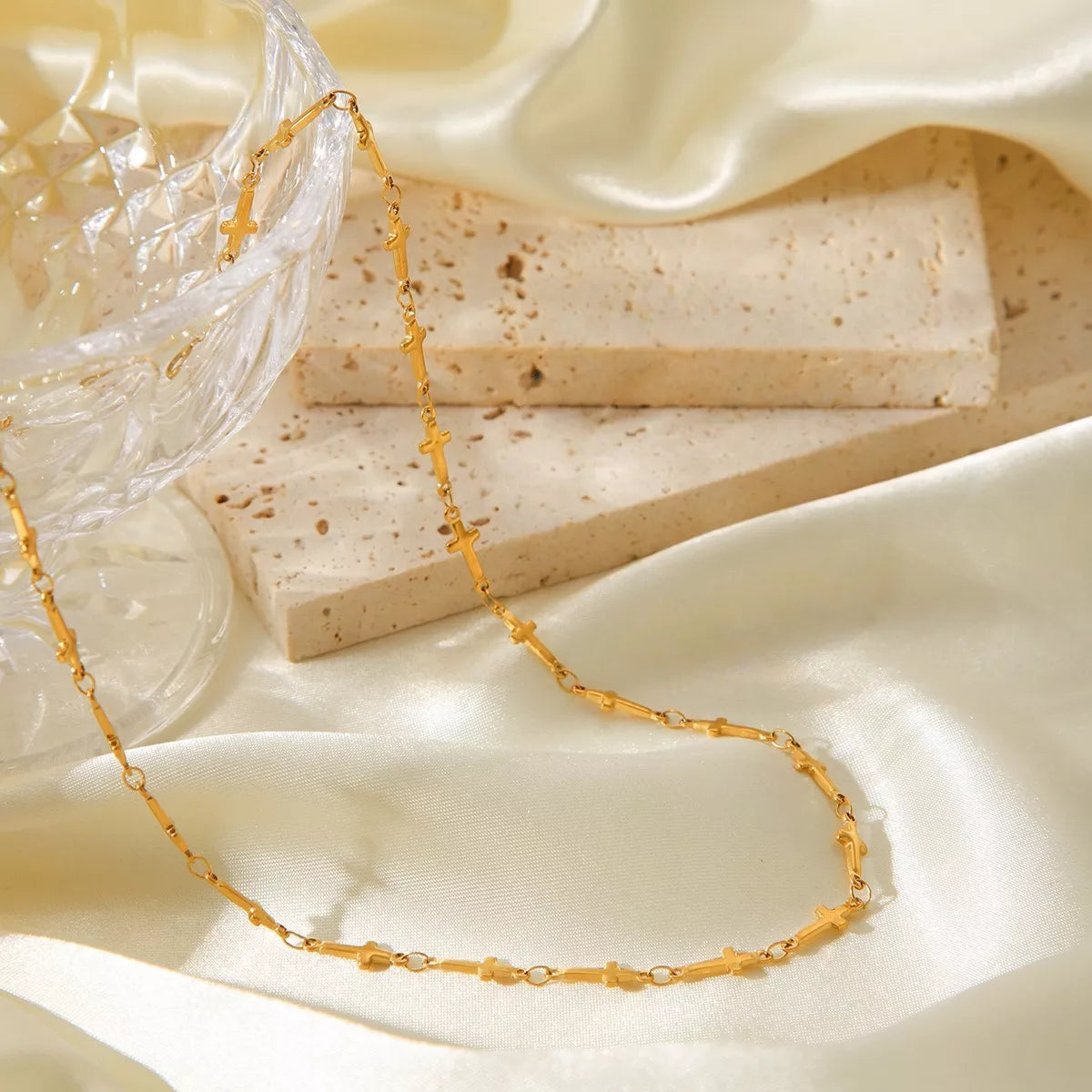 Gold-plated cross necklace from Plush Fashion Hub featuring a delicate chain and a prominent cross pendant.