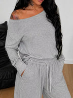 Plus size loose fit one-shoulder T-shirt and pants set by Trendsi, featuring comfortable, relaxed fit fabric and stylish design.