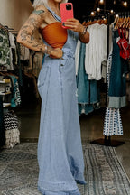 Women's distressed wide leg denim overalls with casual relaxed fit, featuring a trendy, fashionable style from Plush Fashion Hub.