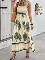 Smocked printed wide strap maxi dress by Plush Fashion Hub featuring a flowing silhouette and vibrant floral pattern.