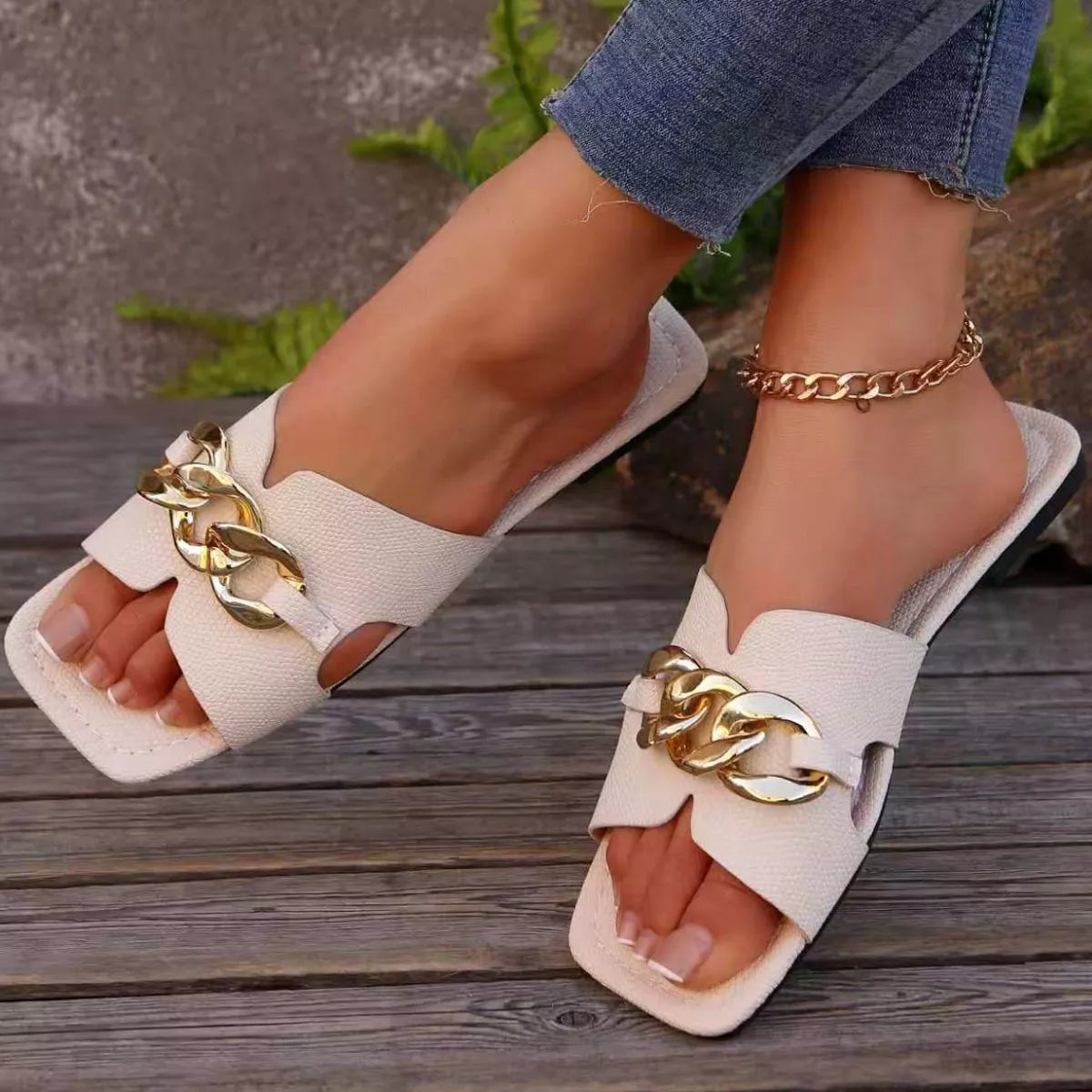 Chain embellished slide sandals by Plush Fashion Hub featuring a stylish open-toe design and decorative chain accents.