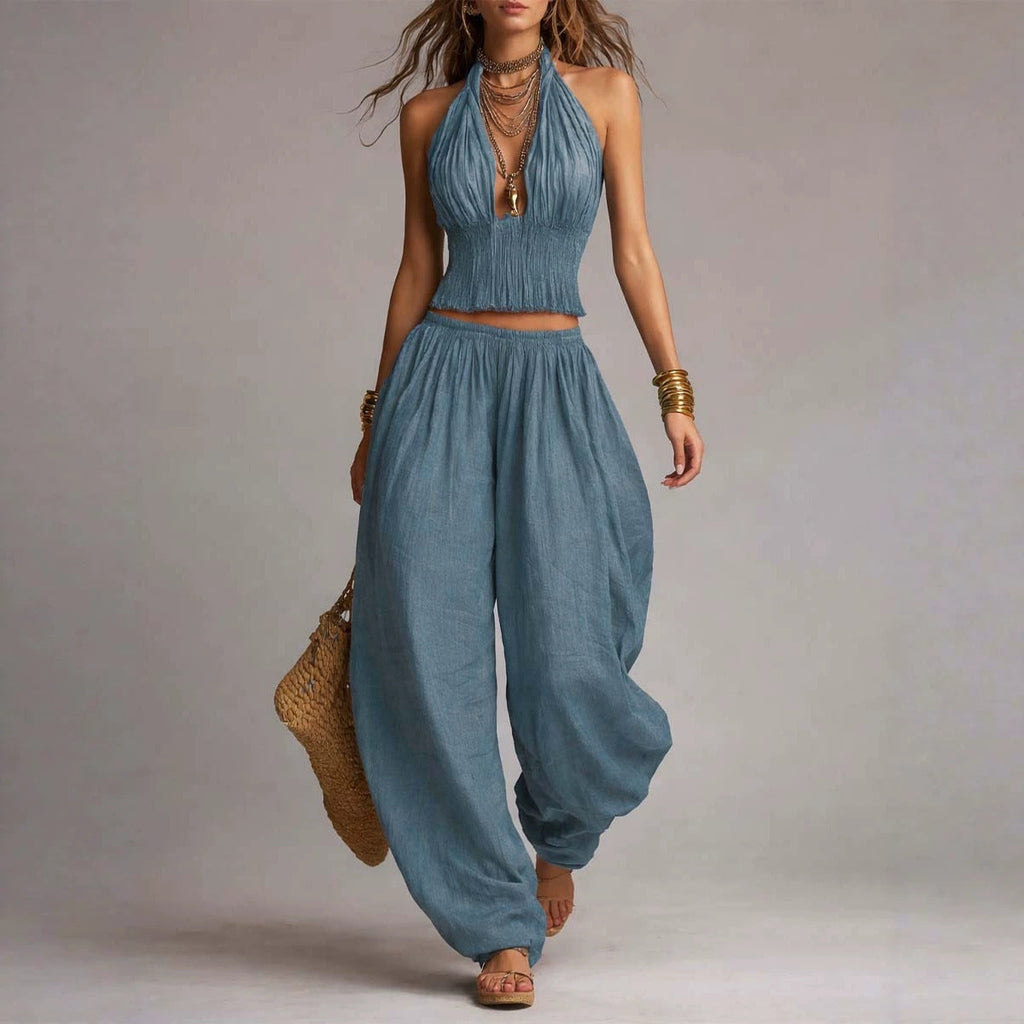 Women's sleeveless backless halter top and wide-leg pants set by FitiqueFit, shown in a stylish, coordinated outfit.