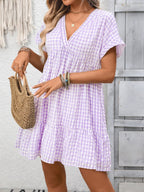 Lightweight plaid V-neck mini dress with ruffle hem by Plush Fashion Hub, perfect for seasonal stylish looks.