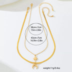 Gold-plated moon and star necklace set with 18K gold finish, featuring two delicate pendants on a fine chain.