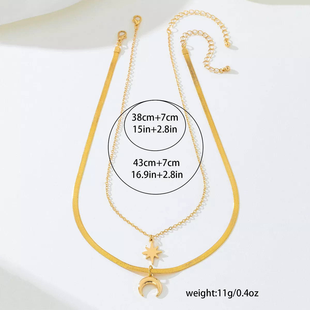 Gold-plated moon and star necklace set with 18K gold finish, featuring two delicate pendants on a fine chain.