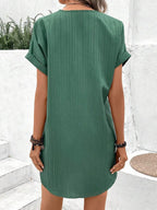 Short sleeve solid button-front V-neck dress by Plush Fashion Hub, casual shirt dress with a relaxed fit and front buttons.