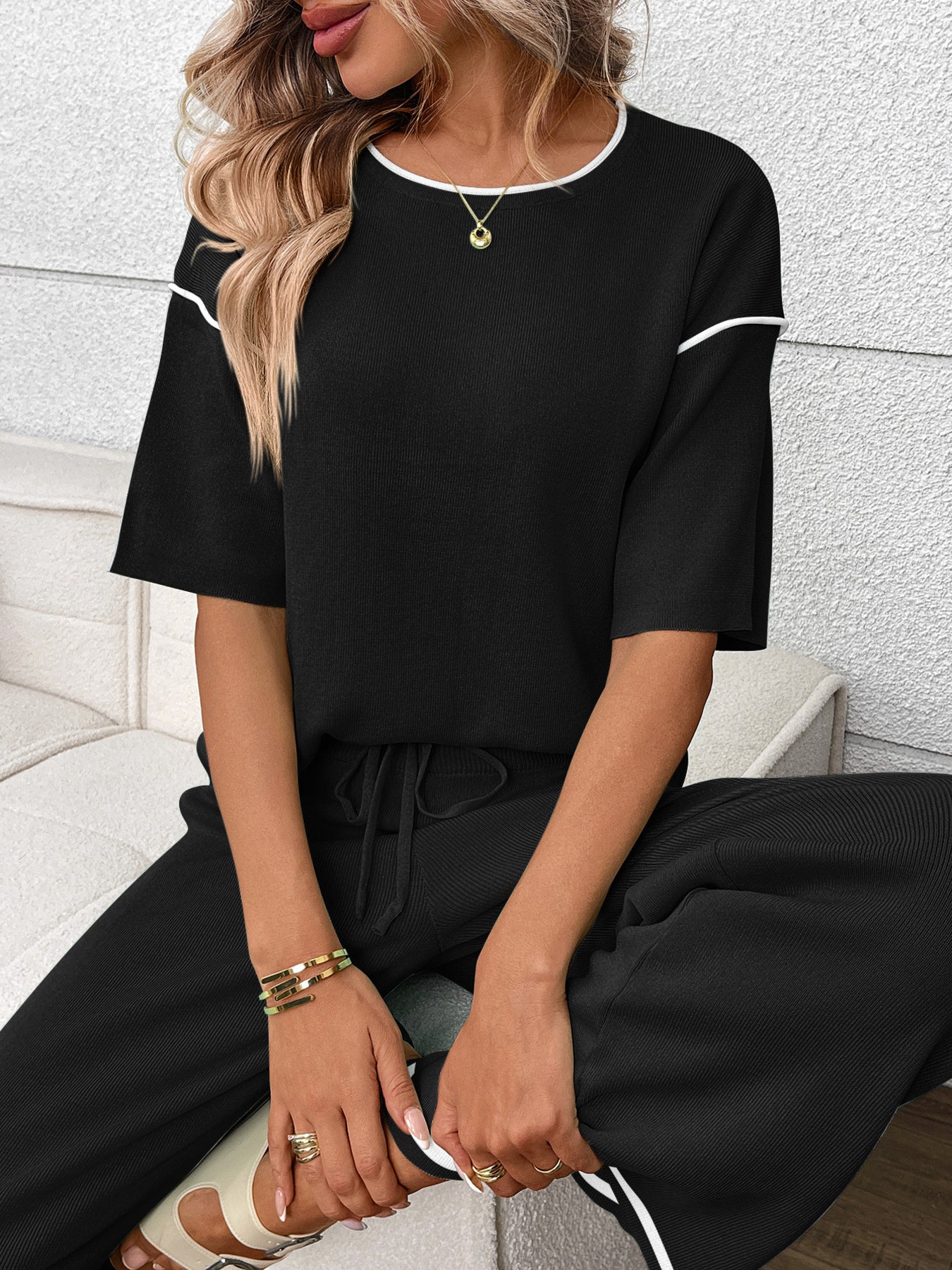 Women's casual two-piece lounge set with round neck top and drawstring pants by Trendsi, shown in a comfortable, relaxed fit.