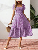 Floral print smocked ruffle sleeve midi dress by Trendsi featuring lightweight fabric and summer-ready design.