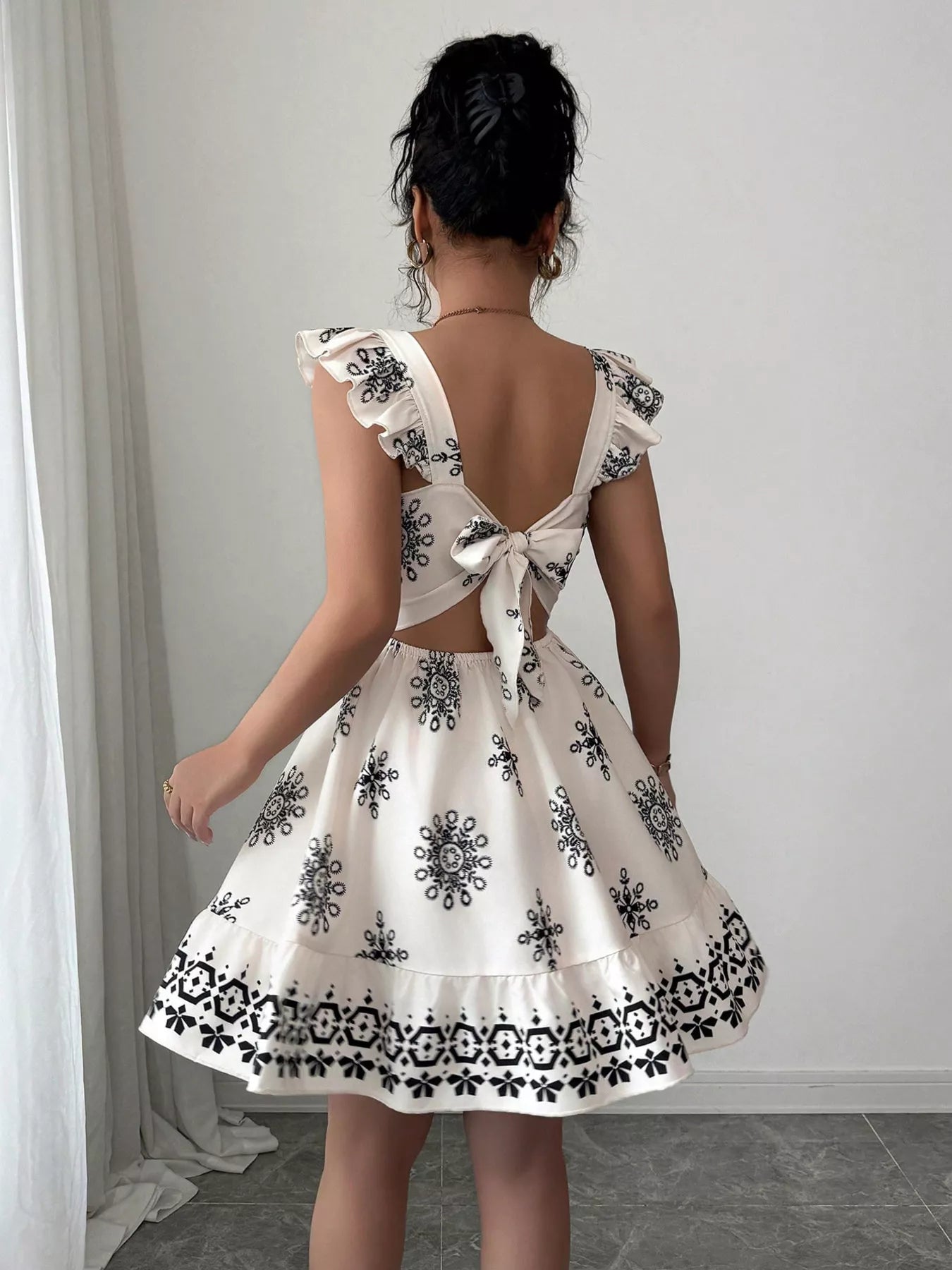 Printed bow back square neck mini dress by Plush Fashion Hub, featuring a stylish square neckline and bow detail in vibrant print.