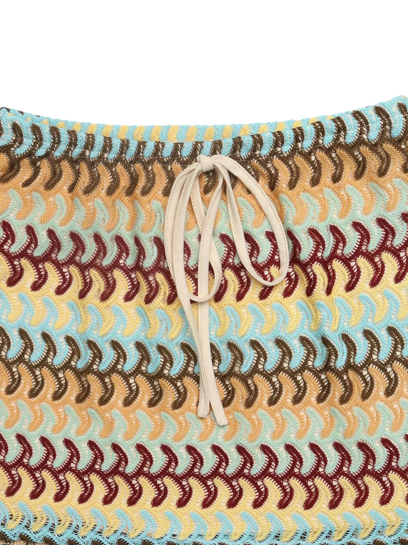 Crochet drawstring mini skirt by Trendsi featuring a textured crochet design and adjustable waistband on a neutral background.