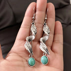 Turquoise alloy leaf-shaped artificial earrings with intricate design, crafted by Shopimist, displayed on a white background.