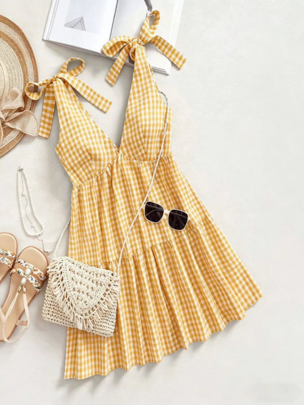 Gingham tie-shoulder mini dress from Plush Fashion Hub, featuring a stylish skirt with ruffled shoulder details and a fitted waist.