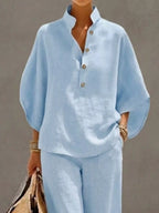 Plus size women's two-piece set with button details and 3/4 sleeves, featuring a stylish dress from Trendsi.