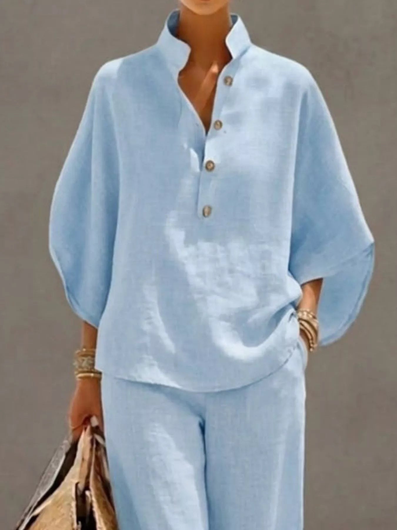 Plus size women's two-piece set with button details and 3/4 sleeves, featuring a stylish dress from Trendsi.