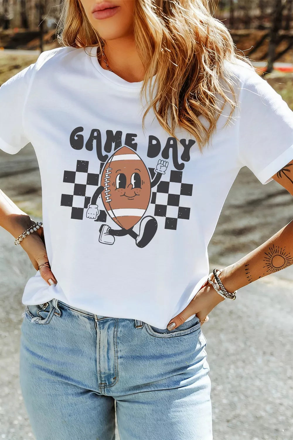 Plush Fashion Hub Game Day football graphic T-shirt in black, featuring bold football and sports team designs on front.