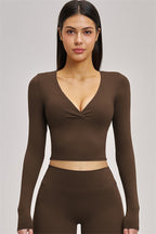 Fitglutes Activewear long sleeve crop top from The Swoon collection, shown in black, with fitted design and stretchy fabric.
