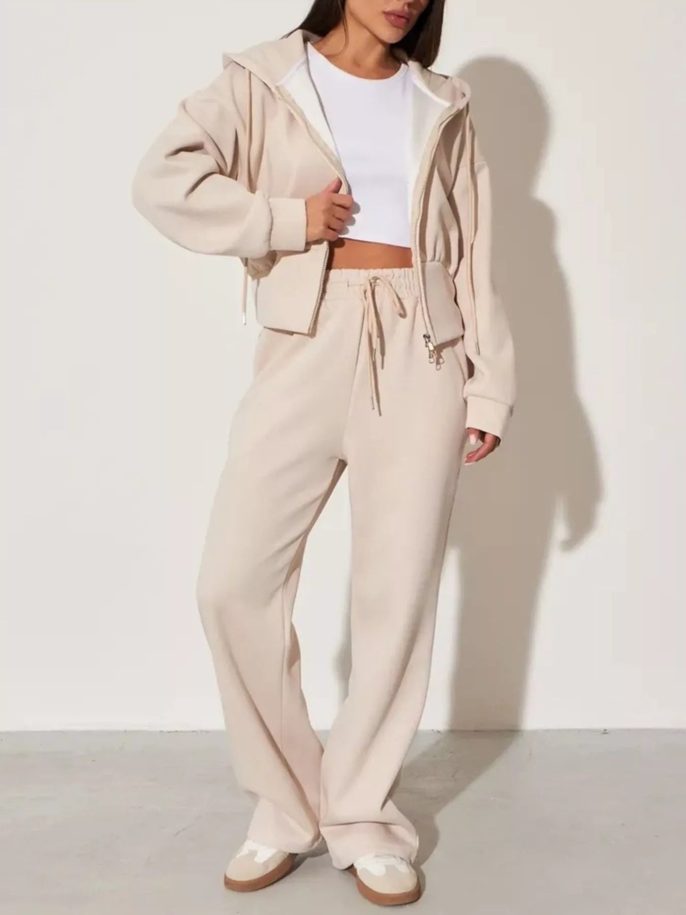 Plush Fashion Hub zip-up hoodie and wide-leg pants loungewear set, soft fabric with a relaxed fit, displayed on a hanger.
