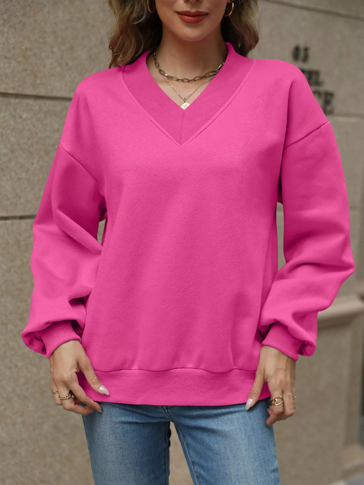 V-neck solid color casual sweatshirt by Trendsi, featuring a comfortable fit and soft fabric, shown in a neutral tone.