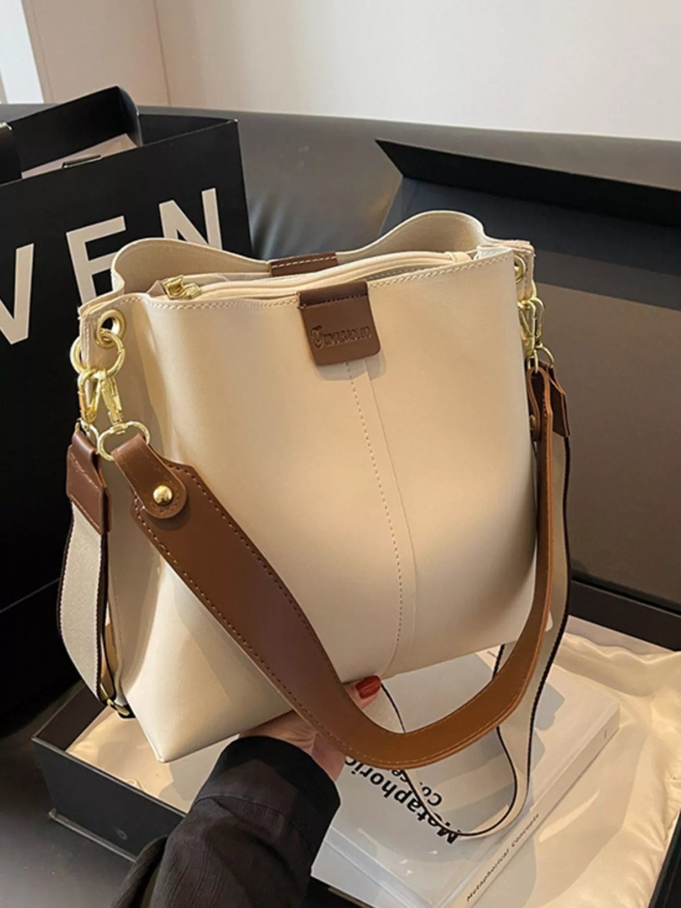 Plush Fashion Hub PU leather crossbody handbag with adjustable strap, featuring a sleek design and compact size.