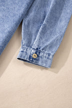 VYSN Raw Hem Button Down Long Sleeve Denim Dress displayed on a hanger, showcasing its casual style and raw hem detail.